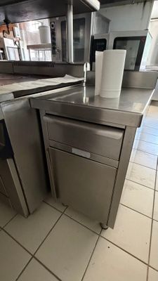 a silver dishwasher sitting on a counter in a kitchen