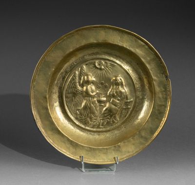 a gold plate with an image of a woman and child on it