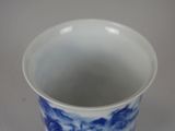 a blue and white cup sitting on a table