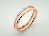 a rose gold ring with diamonds on a white background