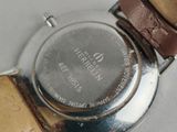 a close up of a wrist watch with a brown strap