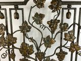 a metal gate with a bunch of flowers on it