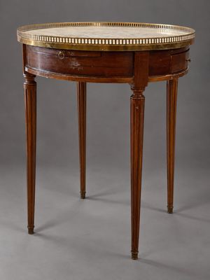 a round table with a marble top and wooden legs