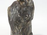 sculpture of a bird on a stand on a white surface