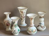 five vases that have been painted with flowers on them