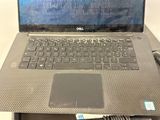 laptop computer sitting on top of a desk with a mouse on it