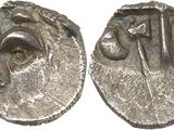 a close up of two silver coins on a white surface