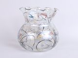 a glass vase with a floral design on it