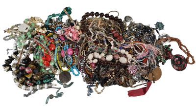 a pile of assorted jewelry on a white surface