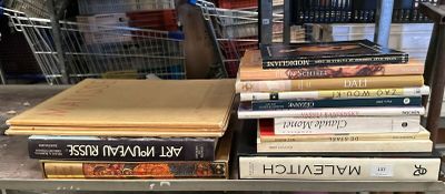 many books stacked on a metal shelf in a store