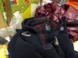 a pile of clothing on a table in a store