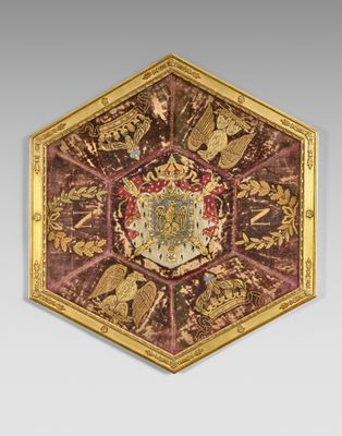 an image of a red and gold plate with a coat of arms on it