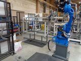 a robot that is standing in a room with a lot of shelves