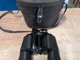 une vieille paire de jumelles posée sur une table en bois
