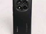 a close up of the back of a black phone on a white surface