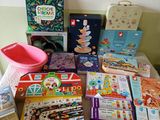 many children ' s books and toys on a table