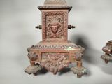 a small wooden chair with a carved face on it
