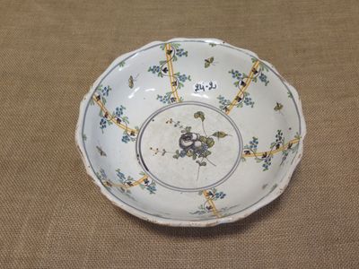 a white bowl with blue and yellow flowers on it