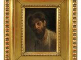 un tableau représentant un homme barbu dans un cadre en or