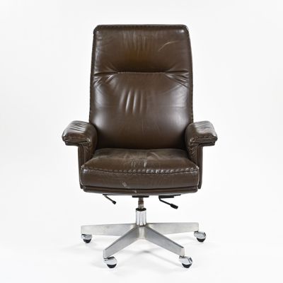 brown leather office chair on casteors on white background