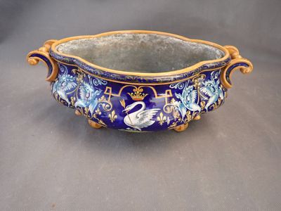 a blue and gold bowl with a swan design on it