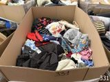 a cardboard box filled with clothes and other items