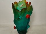 a glass vase with a cactus plant inside of it