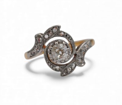 a close up of a diamond and gold ring on a white background