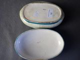 pair of porcelain bowls with handles and handles in the shape of a boat
