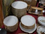 many plates and bowls that are on a table