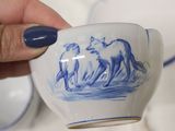 a person holding a cup with a picture of a horse on it