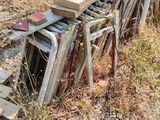 a pile of old wooden chairs sitting on the ground