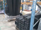 a large amount of black plastic pipes in a warehouse