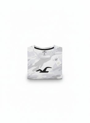 a white t - shirt with a camouflage print on the front