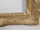 a picture of a gold picture frame on a white surface