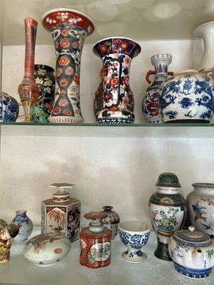 many different vases on the shelves in this room