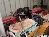 many different types of tractors parked in a garage