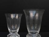 two empty glass cups sitting on a table