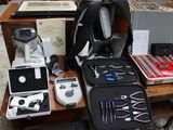 a table with many items on it including a backpack, a game controller, a game controller, and other items