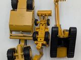 a yellow toy truck and a bulldozer on a white surface