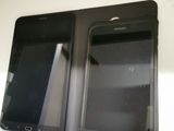 two cell phones sitting side by side on a table