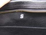 someone is holding a black purse with a white s on it