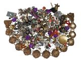a pile of assorted jewelry on a white surface