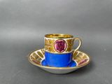 a close up of a cup and saucer on a table