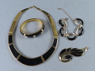 un collier, un bracelet et une bague posés sur une table