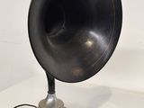 a black and silver speaker on a white table