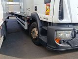 a white truck that is parked next to a trailer