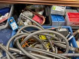 a lot of hoses in a blue box on the floor