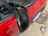 an image of a red car with its door handle open