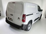 a white van that is parked in a white room